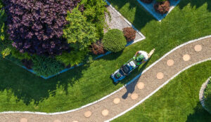 A walkway at a home shown from above with a lawn mower next to it